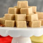 front on picture of eggnog fudge stacked in a pyramid on a cake stand