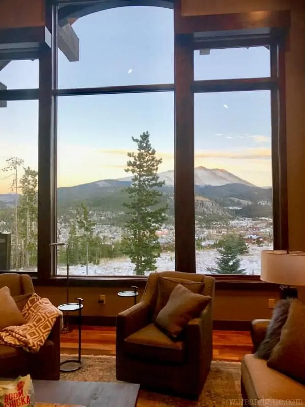 A picture of a window in the living room showing the beautiful mountain landscape. 