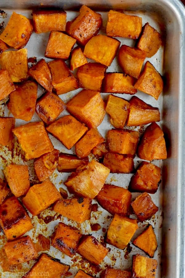 In a baking pan, the Sweet Potatoes are cut into cubes with some caramelization around the ages. 