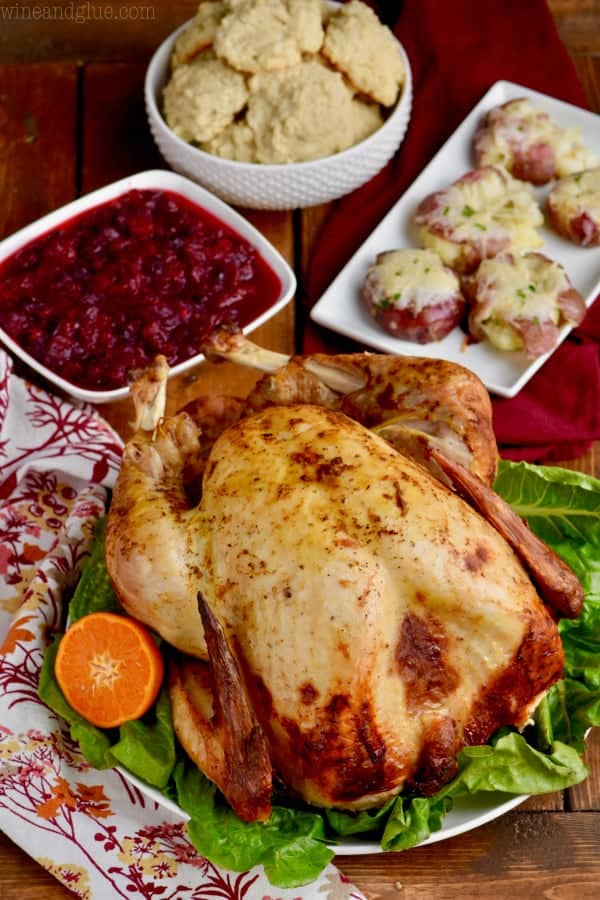 A Thanksgiving spread of the Easiest Thanksgiving Menu (Turkey, cranberry sauce, baked potato, and biscuits). 