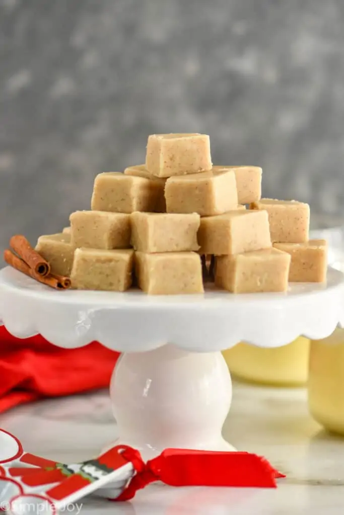 front on picture of eggnog fudge stacked in a pyramid on a cake stand