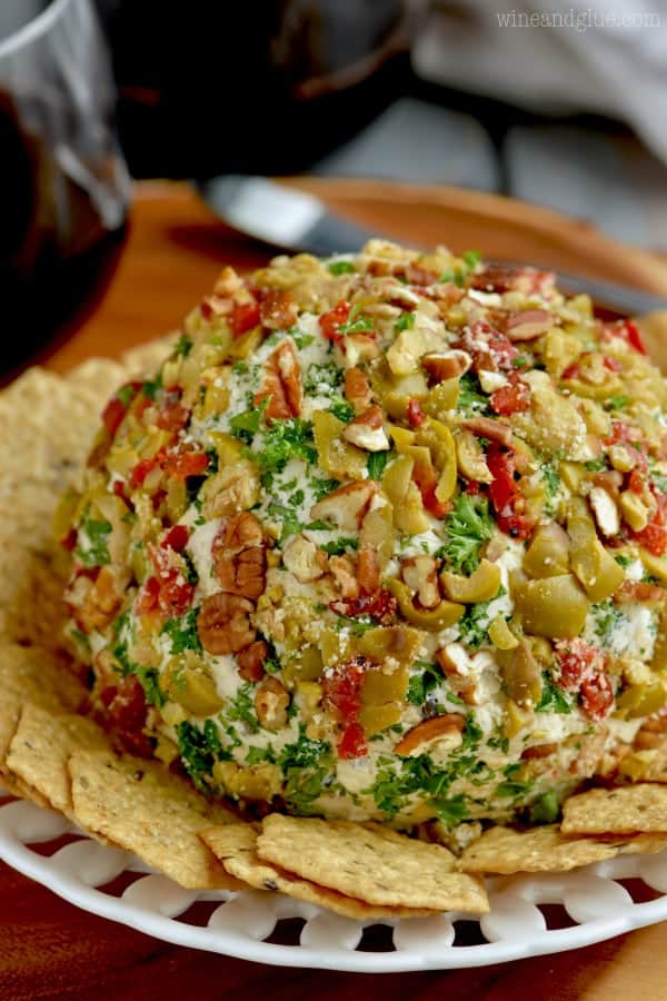 The Olive Cheeseball is covered with pecans, olives, parsley, and parmesan cheese