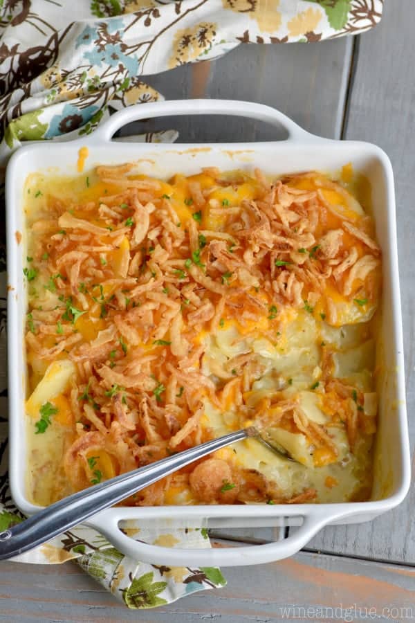 A overhead photo of The Best Scalloped Potatoes with the bottom right corner scooped out. 