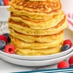 pinterest graphic of stack of six buttermilk pancakes with a pad of butter on top
