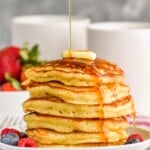stack of buttermilk pancakes with syrup being drizzled over them - 14