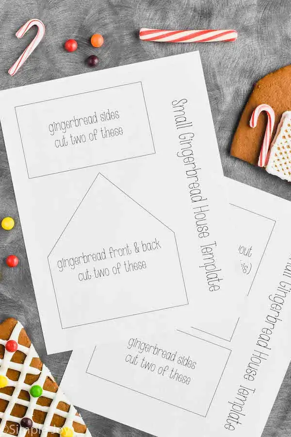 overhead photo of gingerbread house template printable next to gingerbread pieces