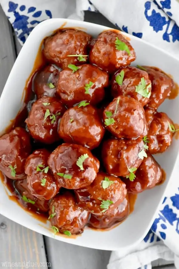 An overhead photo of the Honey BBQ Instant Pot Cocktail Meatballs on a white plate garnished with parsley. 
