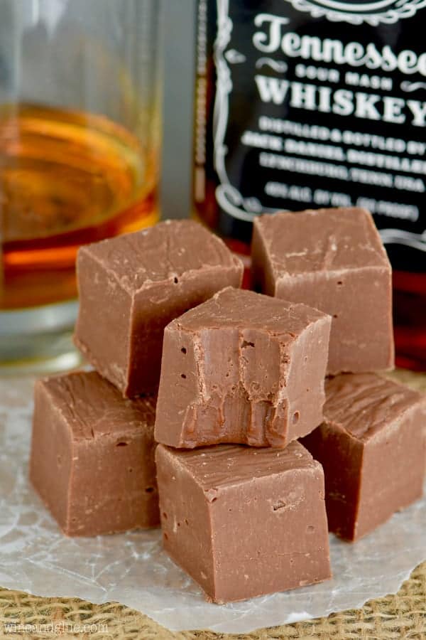 A pile of cubed Jack Daniels fudge. One of the top cubes has a small bite out of it. 