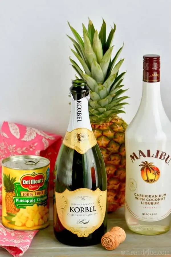 A picture of the ingredients (pineapple chunks, Champagne, and Caribbean Rum with Coconut Liqueur)