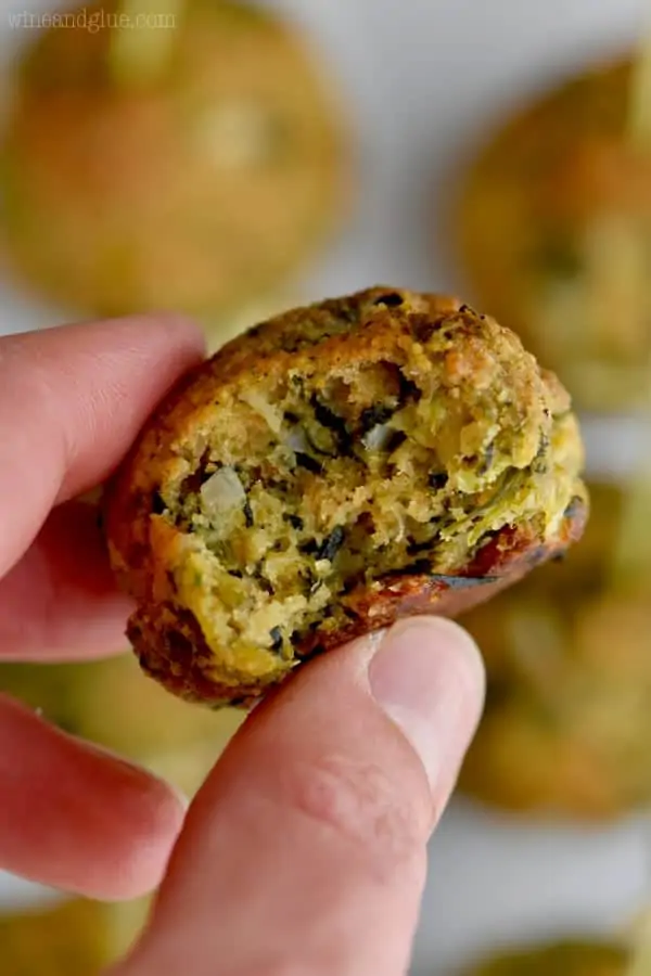 Between someone's index and thumb, the Spinach Ball has a small bite mark out of it. 