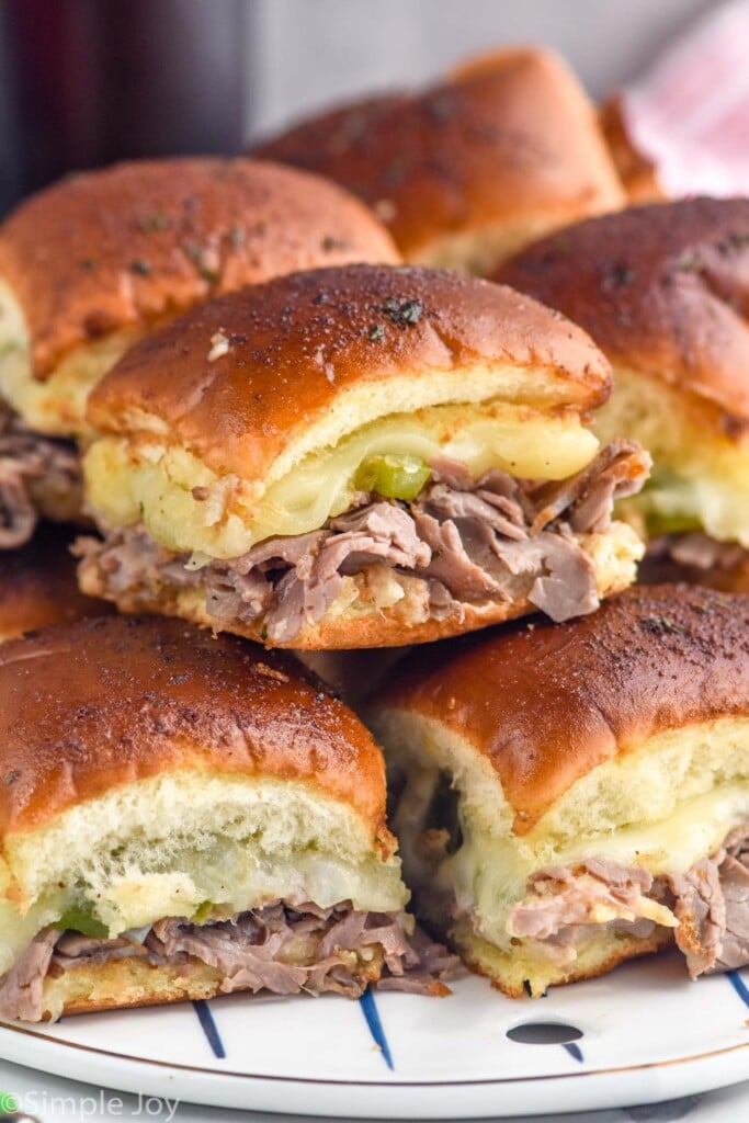 Side view of a platter of Philly Cheesesteak Sliders stacked on top of each other