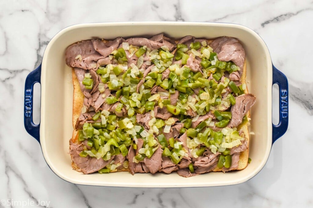 Overhead photo of a baking dish of ingredients for Philly Cheesesteak Sliders recipe