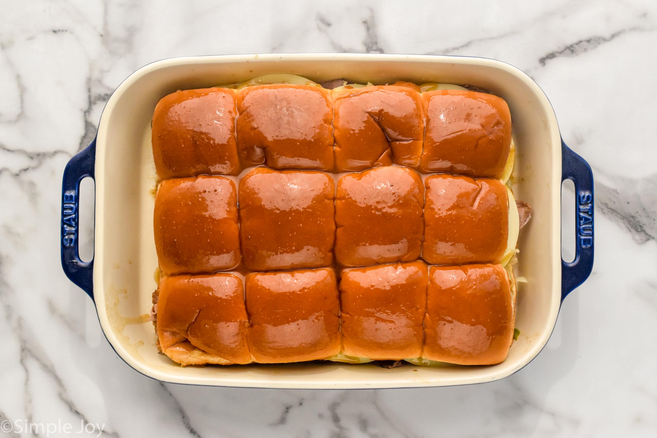 Overhead photo of a baking dish of Philly Cheesesteak Sliders recipe