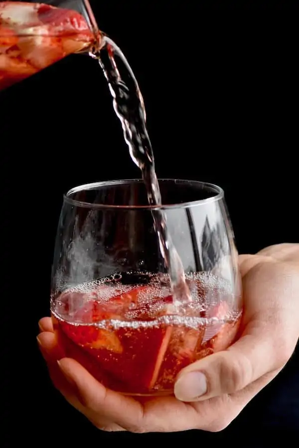 rose sangria being poured into a glass