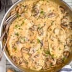 overhead view of a pan full of chicken marsala garnished with parsley