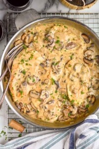 overhead view of a pan full of chicken marsala garnished with parsley
