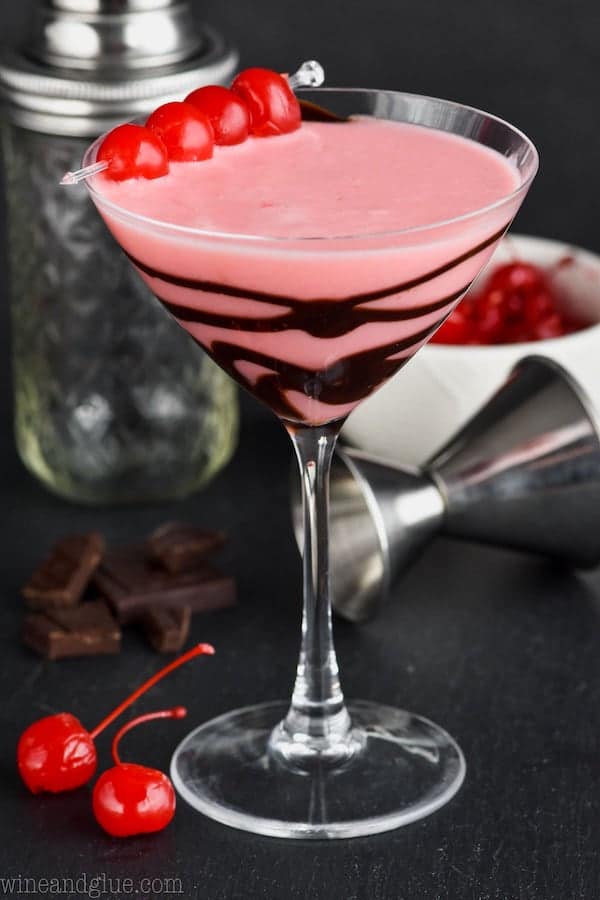 martini glass drizzled with chocolate and full of chocolate covered cherry martini