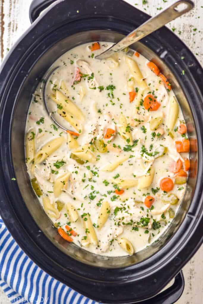 overhead view of a slow cooker full of creamy crockpot chicken noodle soup