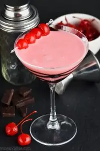 martini glass drizzled with chocolate and full of chocolate covered cherry martini