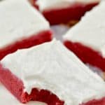 red velvet bar, frosted with cream cheese and a bite missing