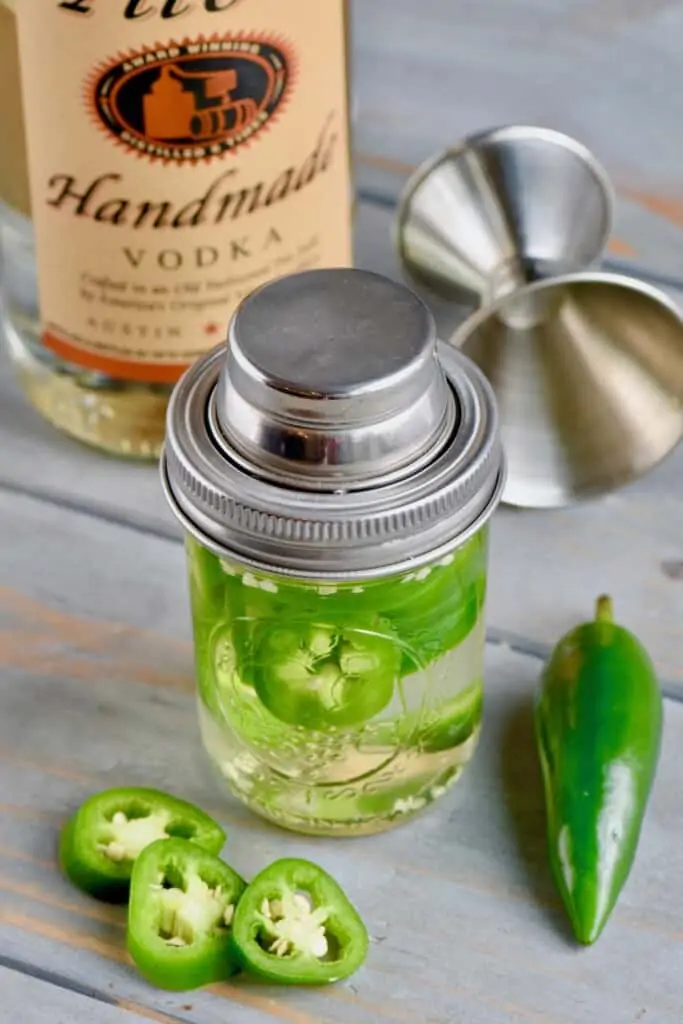 a mason jar full of jalapeno infused vodka