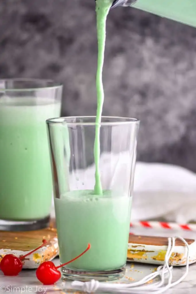shamrock shake recipe being poured into a glass tumbler