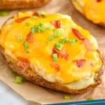 pinterest graphic of a twice baked potato garnished with green onions and bacon on a piece of parchment paper