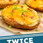 pinterest graphic of side view of four twice baked potatoes on a piece of parchment paper