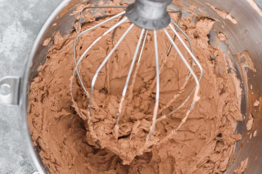 chocolate whipped cream in the base of a large metal mixing bowl