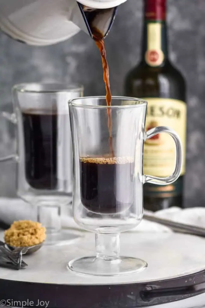 coffee being poured into an Irish coffee mug