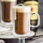 Irish coffee in Irish coffee mugs with cream dripping down the sides
