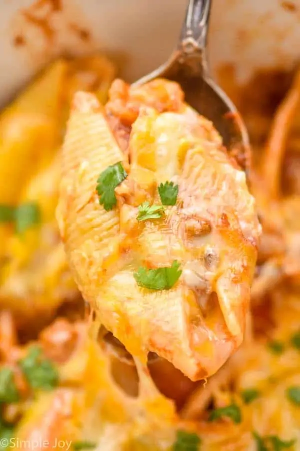 close up of a taco stuffed shell on a spoon