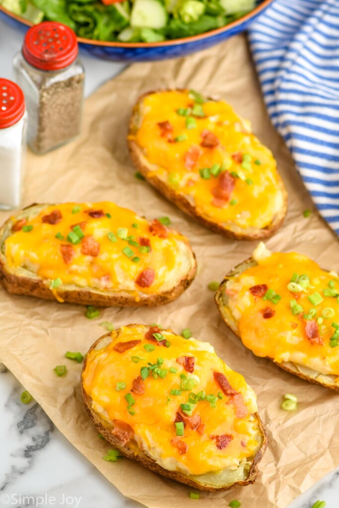 four twice baked potatoes on a piece of parchment paper