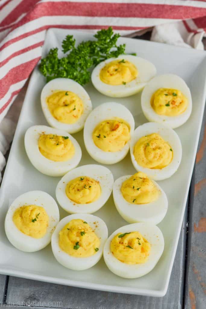 platter of deviled eggs over head.