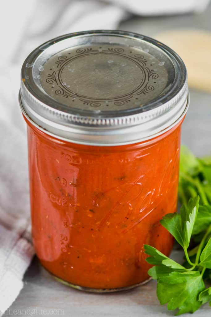jar of marinara sauce with parsley