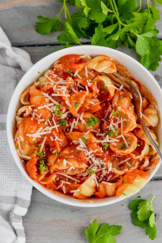 A overhead photo of pasta with the Homemade Easy Marinara Sauce garnished with parsley and shredded parmesan
