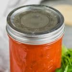 jar of marinara sauce with parsley