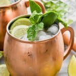 moscow mule with gin in copper mug garnished with mint and lime - 6