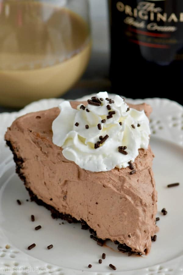 A slice of No Bake Baileys Chocolate Pie with a small dollop of whip cream and chocolate sprinkles.