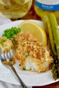 baked fish that is breaded with a fork bite missing