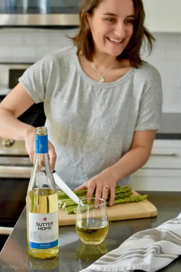wine bottle with woman chopping asparagus