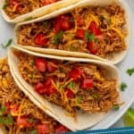 pinterest graphic of overhead of three instant pot chicken tacos, says: instant pot chicken tacos simplejoy.com