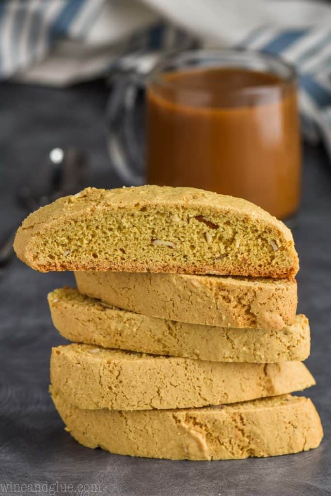 stack of biscotti cookies with coffee in the background