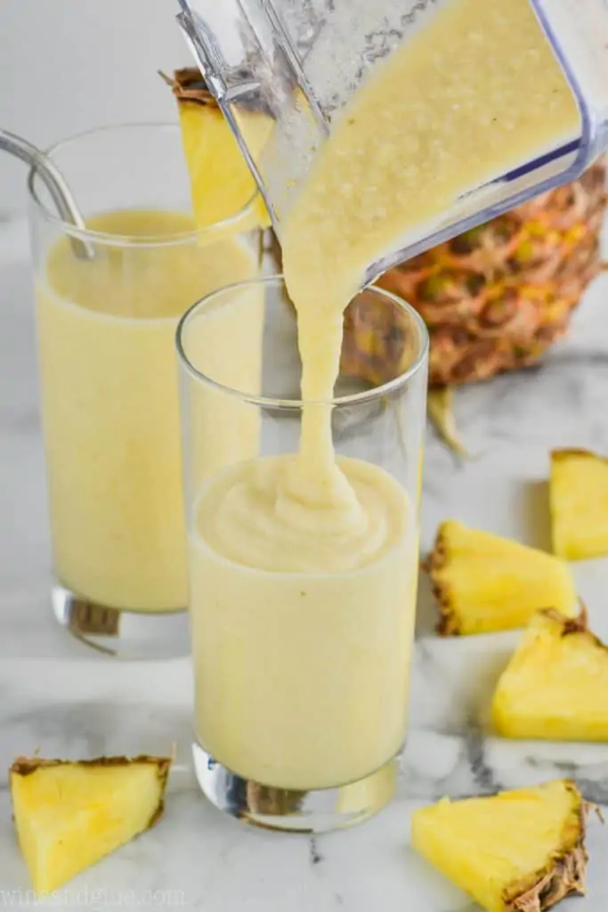 pouring dole whip float into a tall glass