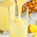 dole whip with rum being poured into a glass