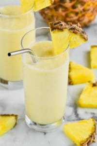 Rum Dole Whip in a glass with pineapple chunks