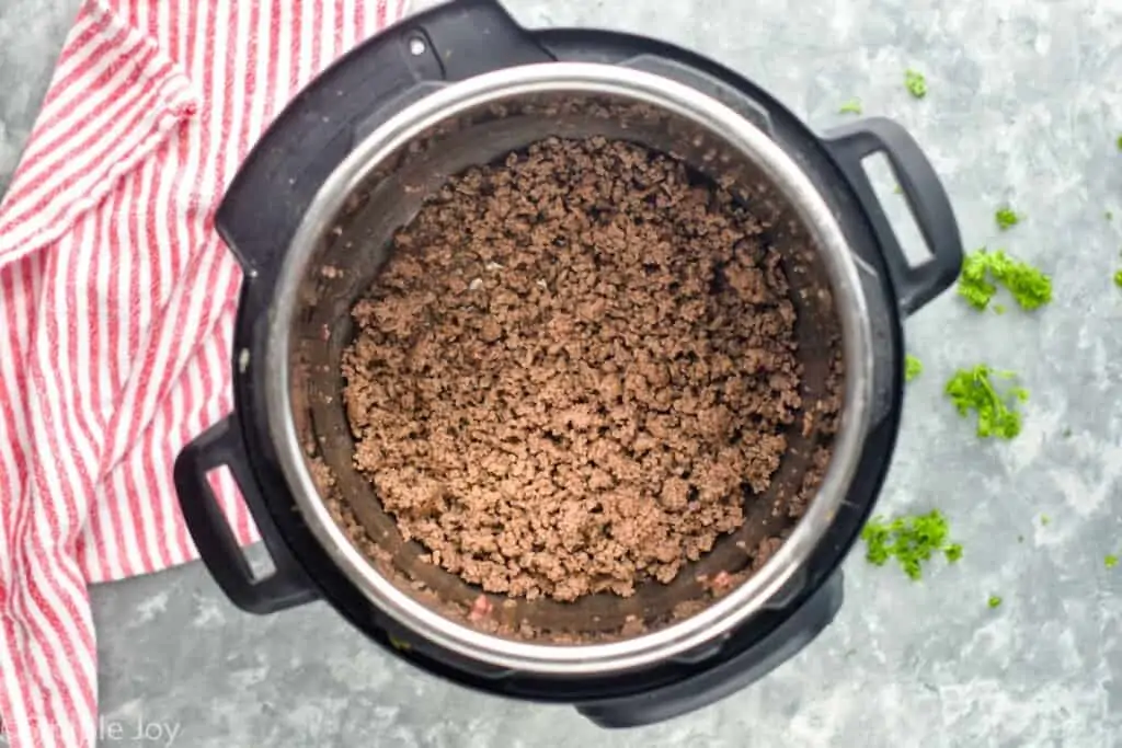 ground beef cooked in the bottom of an instant pot