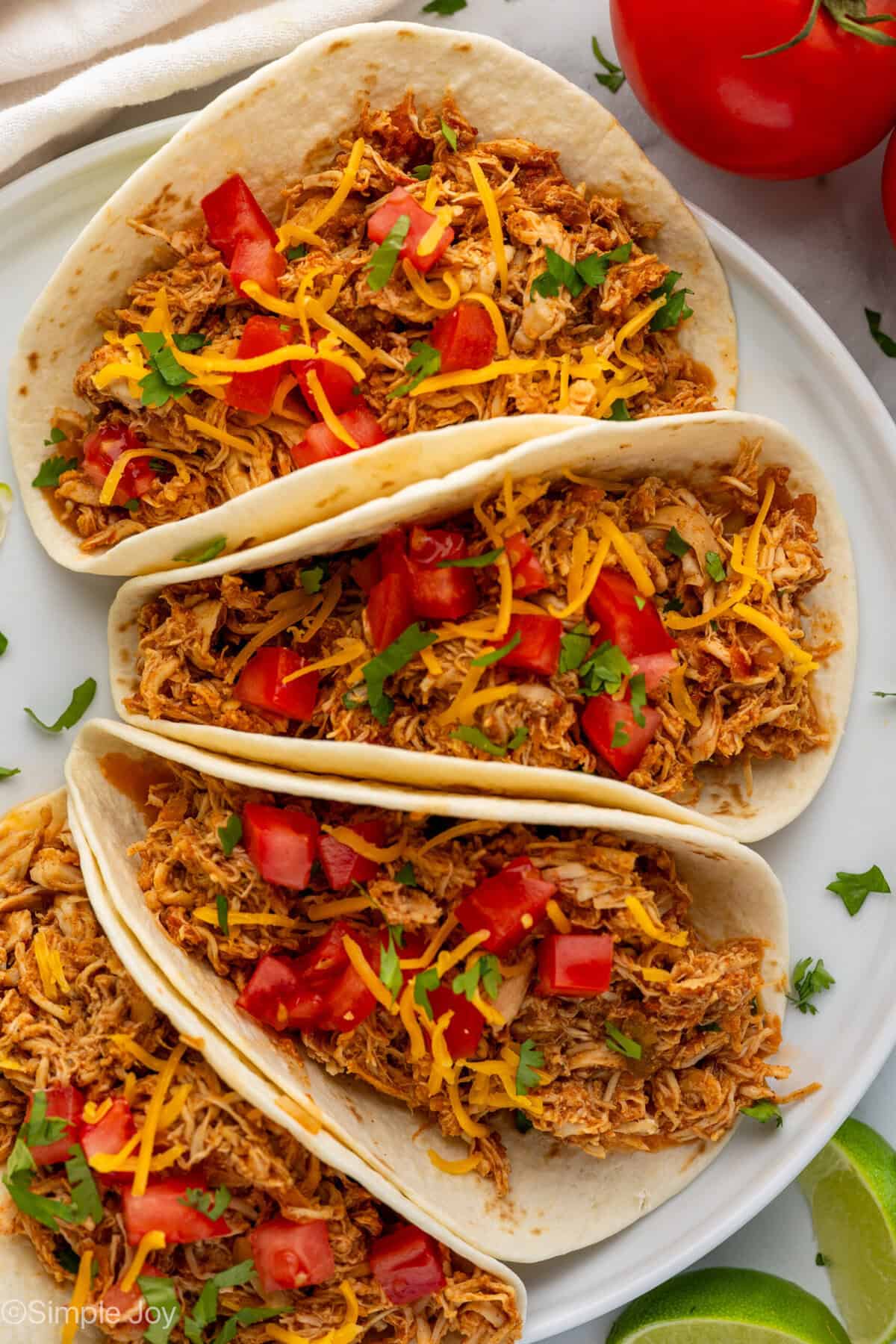 overhead view of three instant pot chicken tacos on a plate with cilantro lime rice