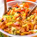 italian pasta salad in a large clear bowl garnished with parsley - 9