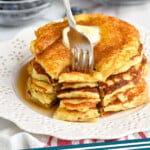 pinterest graphic of stack of yogurt pancakes with a cut made into them, and a fork digging in, says: "yogurt pancakes simplejoy.com"